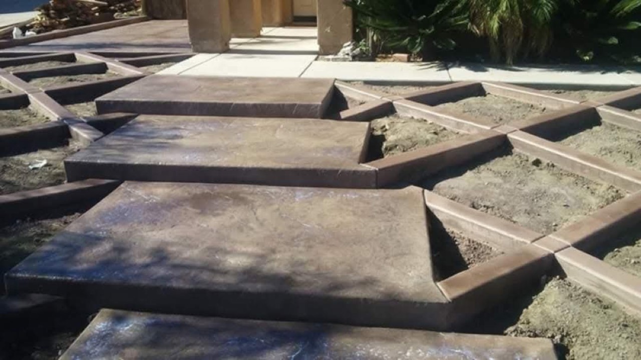 Dark stamped-concrete floating steps and walkway