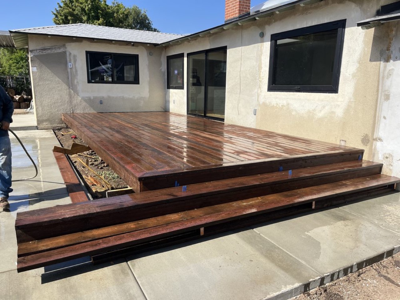 Stained wood deck with adjoining concrete flatwork